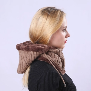 Detail of chunky cable knit winter hood with warm faux fur lining and drawstring ties