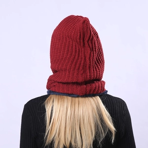 Close-up back view of a red ribbed knit balaclava with thick blue fleece lining texture