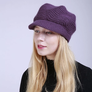 Detail view of the thick purple knitted texture on this warm winter newsboy style cap