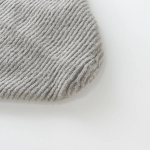 Macro detail of the gray ribbed knit texture on a soft woolen winter ear protection hat