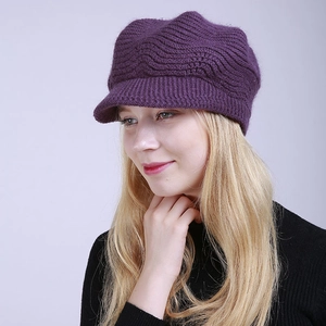 Detail of dark purple knitted visor cap with thick wave-textured pattern for winter