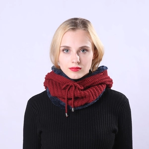 Close-up of knitted wine red warm neck gaiter with blue fleece lining and silver aglets