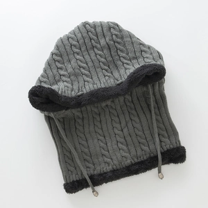 Detailed macro view of heavy knit cable pattern and warm black fleece lining texture