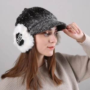Detailed view of women's knitted visor hat with plush earflaps and letter embroidery