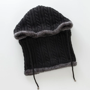 Detailed cable knit texture and soft grey faux fur lining on a black winter hood