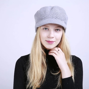 Detail of grey knitted peak cap with wave pattern texture and warm fleece lining