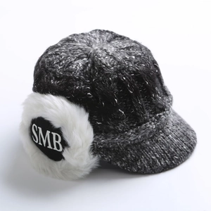Detail of grey knitted winter visor hat with fleece-lined earflaps and SMB logo patch