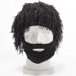 Macro detail of hand-knitted black novelty hat featuring long wig fringe and beard mask