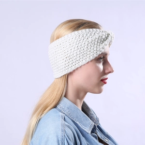 Nahaufnahme von weißem Strickstirnband mit Zopfmuster und vorderem Knotendesign