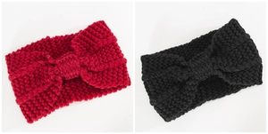 Close-up of thick knitted winter headband texture with knot detail in red and black
