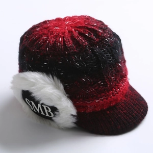 Detail of red and black knit texture with SMB embroidery and faux fur ear flaps