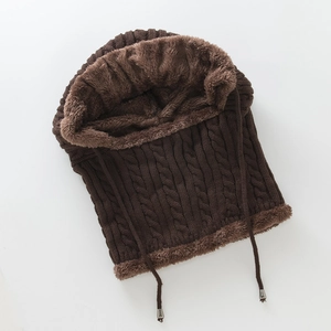 Detail of cable knit texture and thick brown plush lining on winter hooded scarf