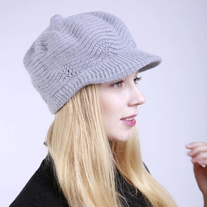 Side view of light gray knitted visor beanie with thick textured wave pattern for winter