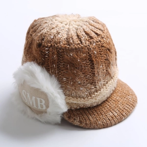 Detailed macro view of camel knit beanie featuring SMB patch and short visor