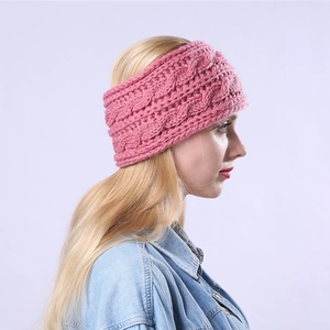 Pink cable knit winter headband worn by a model in a denim shirt for outdoor warmth
