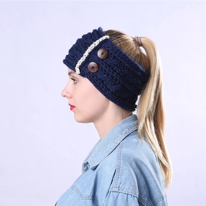 Close-up of cable knit headband with brown wood buttons and delicate lace trim