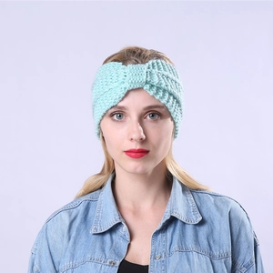 Mint green knitted headband with twist knot design for winter warmth and hair styling