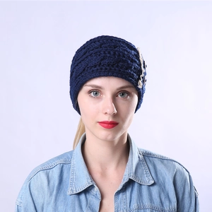 Close-up of navy knit headband featuring twist cable pattern, lace trim and vintage buttons