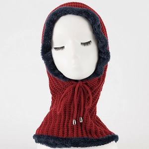 Detail of red knitted balaclava with blue faux fur trim and adjustable drawstrings