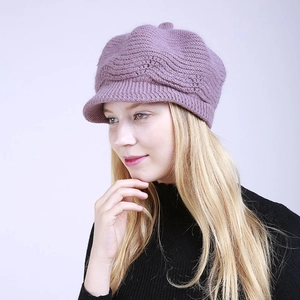 Detailed knit texture and short brim of a warm purple knitted baker boy hat for winter