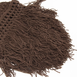 Close-up detail of dark brown handmade crochet knit texture and long fringe tassels