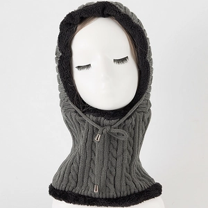 Detail view of winter knitted hooded scarf with cable knit texture and warm fleece lining