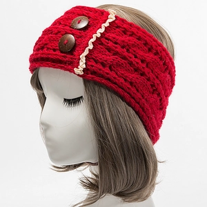 Close-up of red knit headband with cable pattern, lace trim and two wooden buttons
