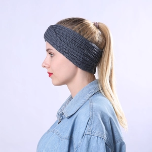 Detail showing grey thick knitted headband with ribbed texture on model for winter warmth