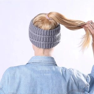 Grey knitted ear warmer headband with thick stripe texture shown on a high ponytail