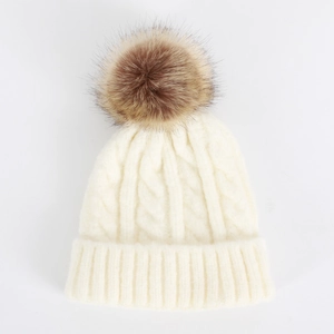 Detail of cable knit texture and faux fur pompom on the off-white winter beanie hat