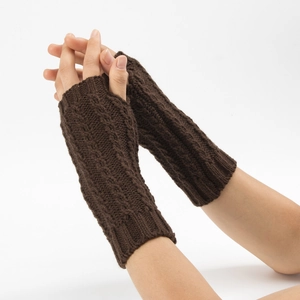 Détail du motif torsadé sur les mitaines chaudes en tricot marron foncé pour l'hiver