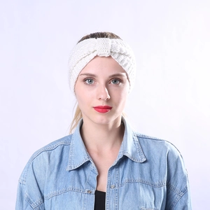 Close-up of white chunky knit headband with a twist knot design on a fashion model