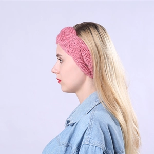 Detail of pink cable knit headband showing thick braided wool texture on model