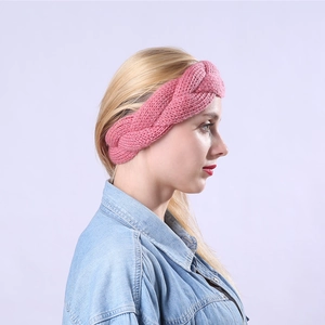 Close-up of pink cable knit headband with thick texture and warm braided design