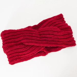 Close-up of red cable knit headband showing twisted knot design and soft ribbed texture