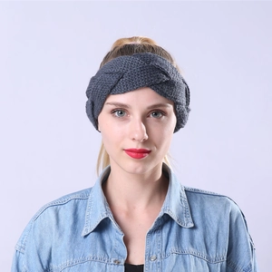 Detailed knit texture of dark grey cable braided headband with thick warm wool material