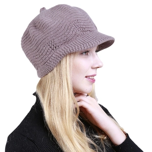 Women's knitted newsboy cap in dusty pink with thick ribbed texture for winter warmth