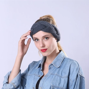 Detail showing the thick cable knit texture and dark grey wool yarn of the headband