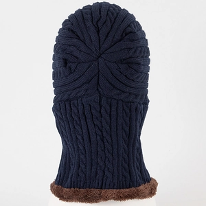 Macro detail of navy cable knit texture with thick brown fleece lining on winter hood