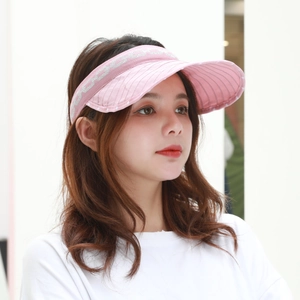 Close-up of pink foldable sun visor cap with silver jacquard texture and wide brim
