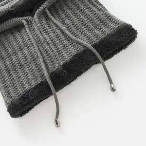Close-up of gray knit neck warmer with thick wave texture and black plush lining detail