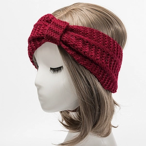 Detail of burgundy thick cable knit headband with twisted knot and ribbed texture