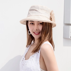 Detail of elegant beige organza flower decoration on a breathable summer sun hat