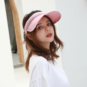 Detailed side view of pink knitted sun visor showing texture and decorative side pattern