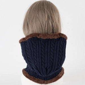 Close-up of deep blue cable knit neck warmer with thick brown faux fur lining detail