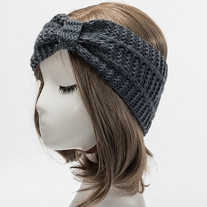 Detail of dark grey knitted headband with stylish twist knot on hair mannequin
