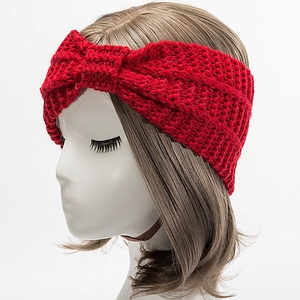 Detail of red knitted headband with twist knot texture on white display model