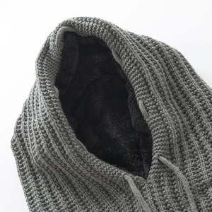 Detailed view of gray waffle knit fabric and thick black fleece lining on hooded scarf