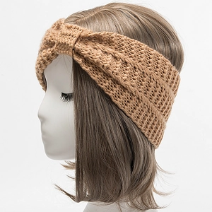 Close-up of camel knit headband featuring a thick twisted texture and warm winter style