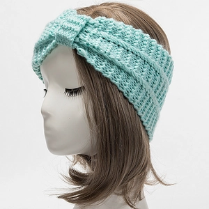 Close-up of mint blue chunky knit headband with twisted knot design for winter warmth